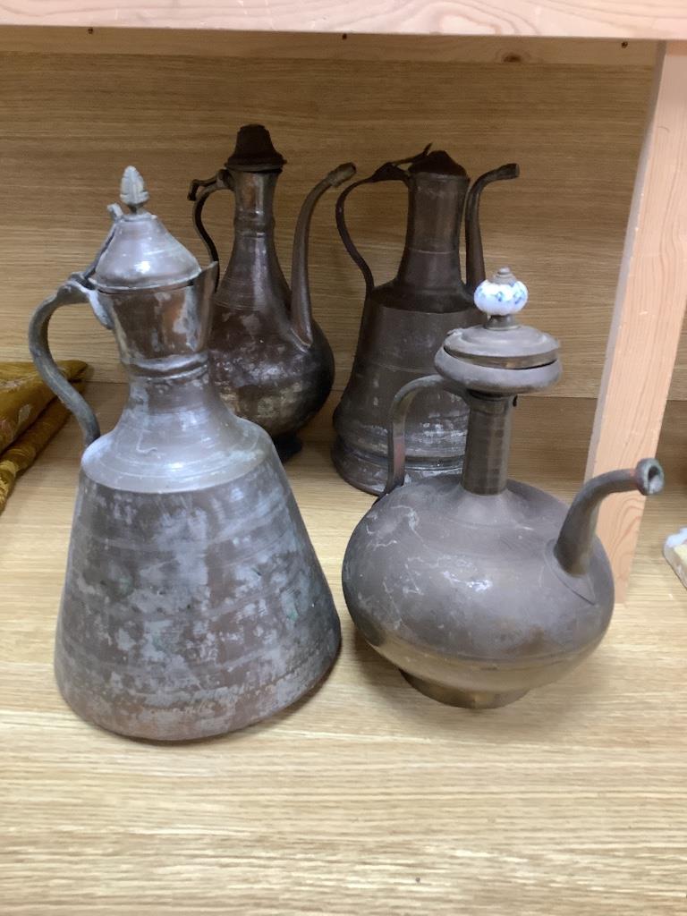 Seven Arabic tinned copper coffee pots, tallest being 34cm high